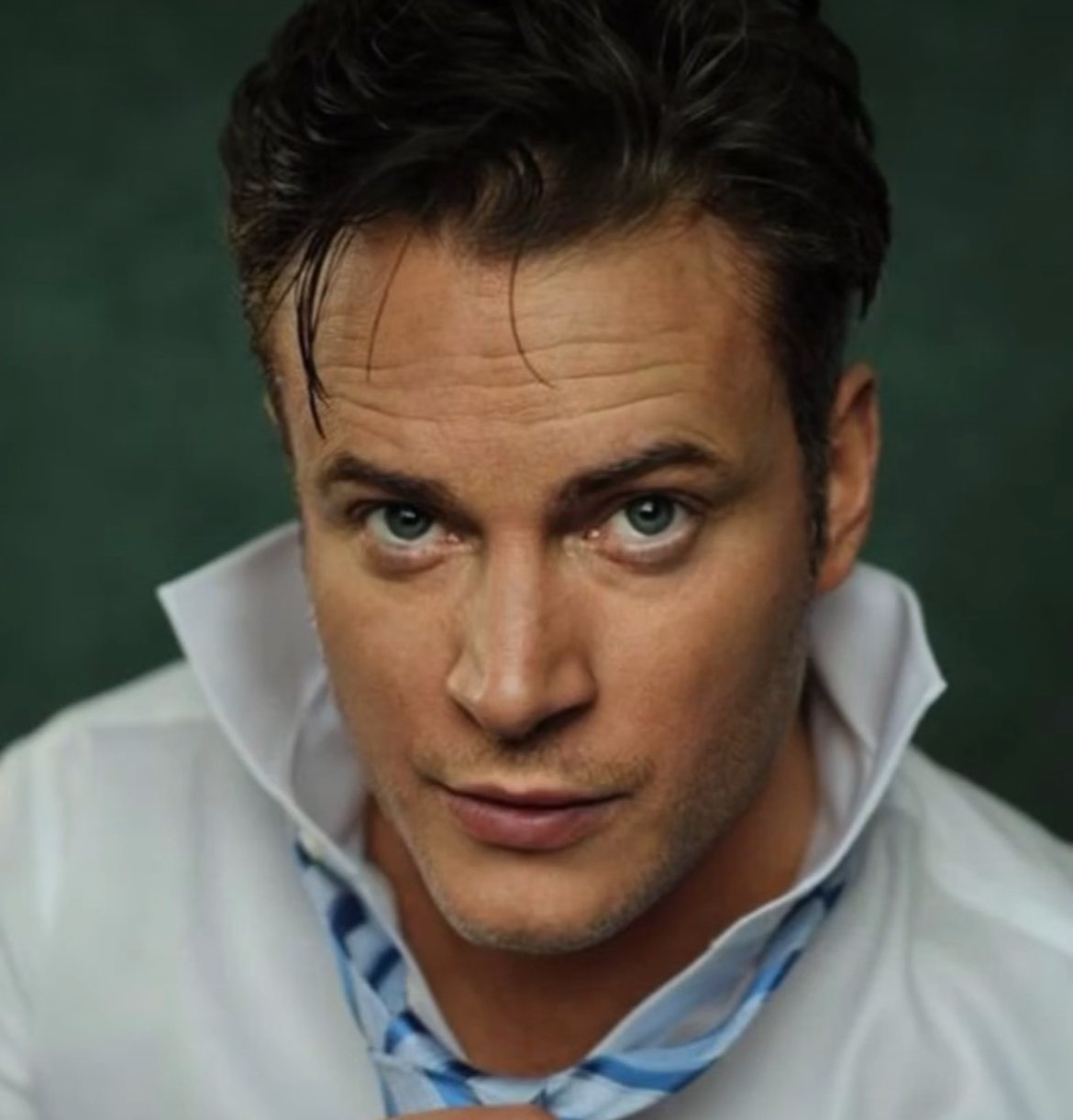 Gary Lucy, British actor, studio portrait in a white shirt and blue tie